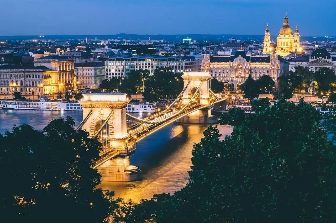 A bridge with Buda castle on the other side, in Budapest - cheap places to visit in Hungary