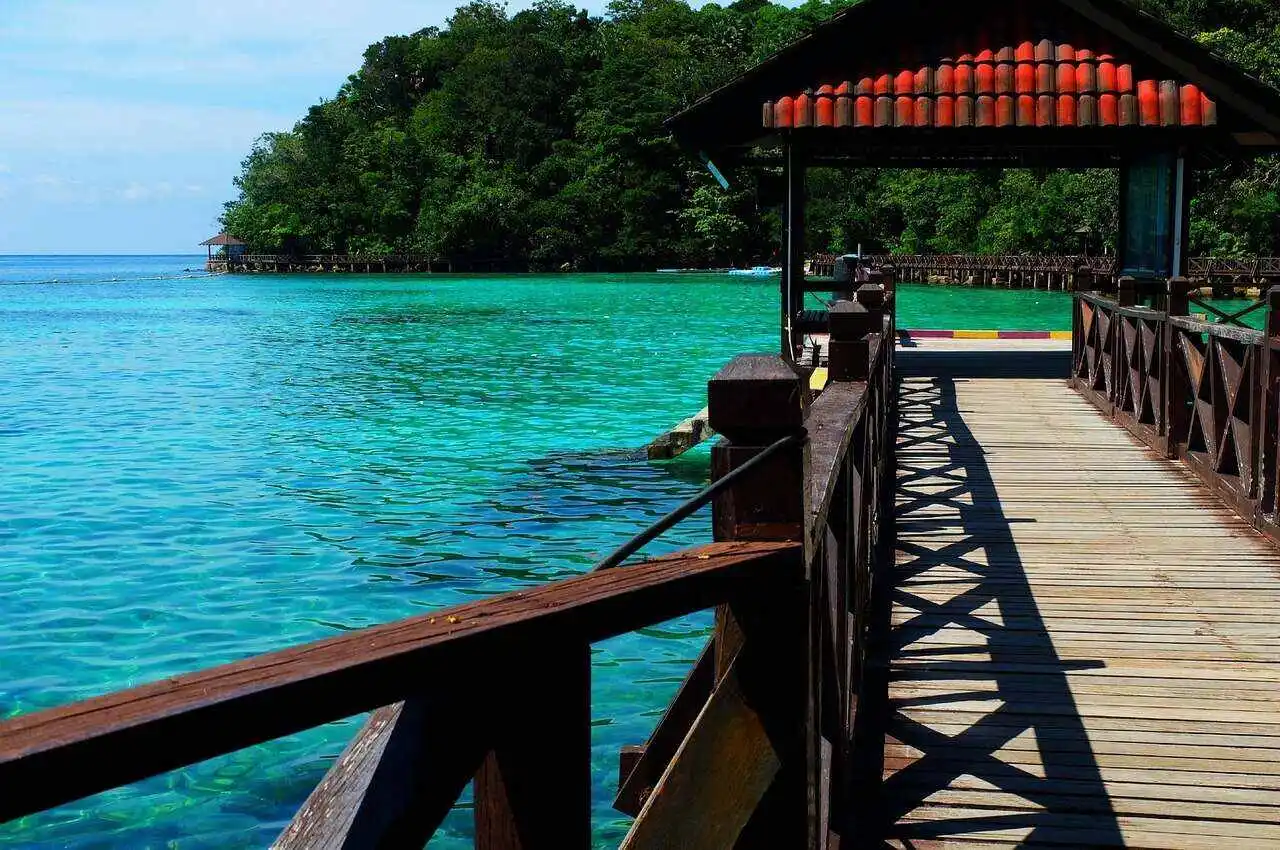 Clear greenish water with an island in front. 