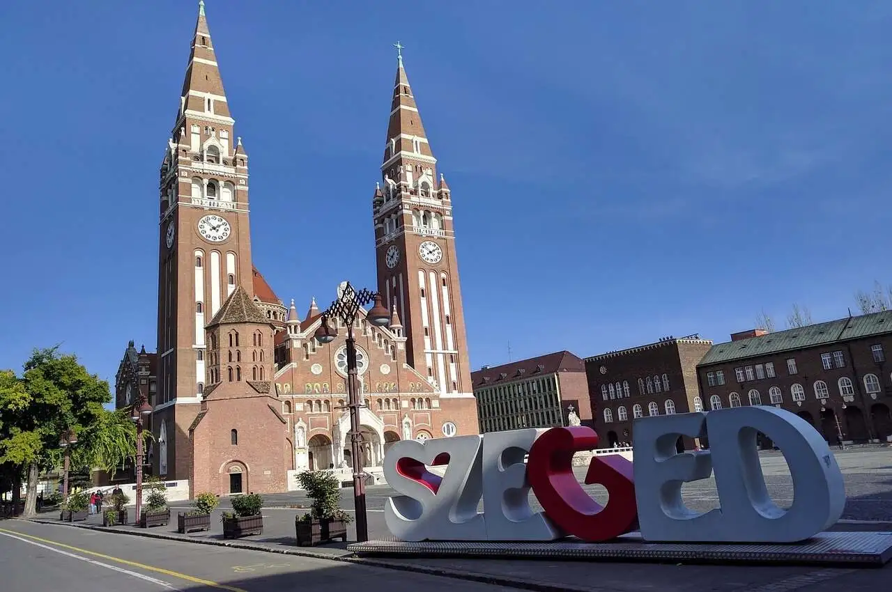 A building with "SZEGED" sign in front of him