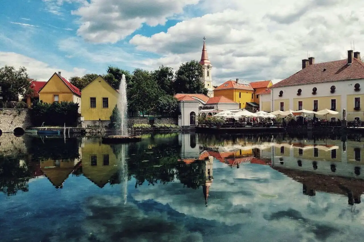 A lake with a neighborhood along the way in Tapolca