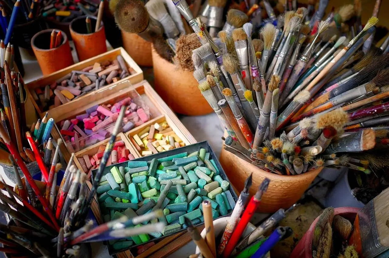 Pencils, brushes, and paint that are used in art.