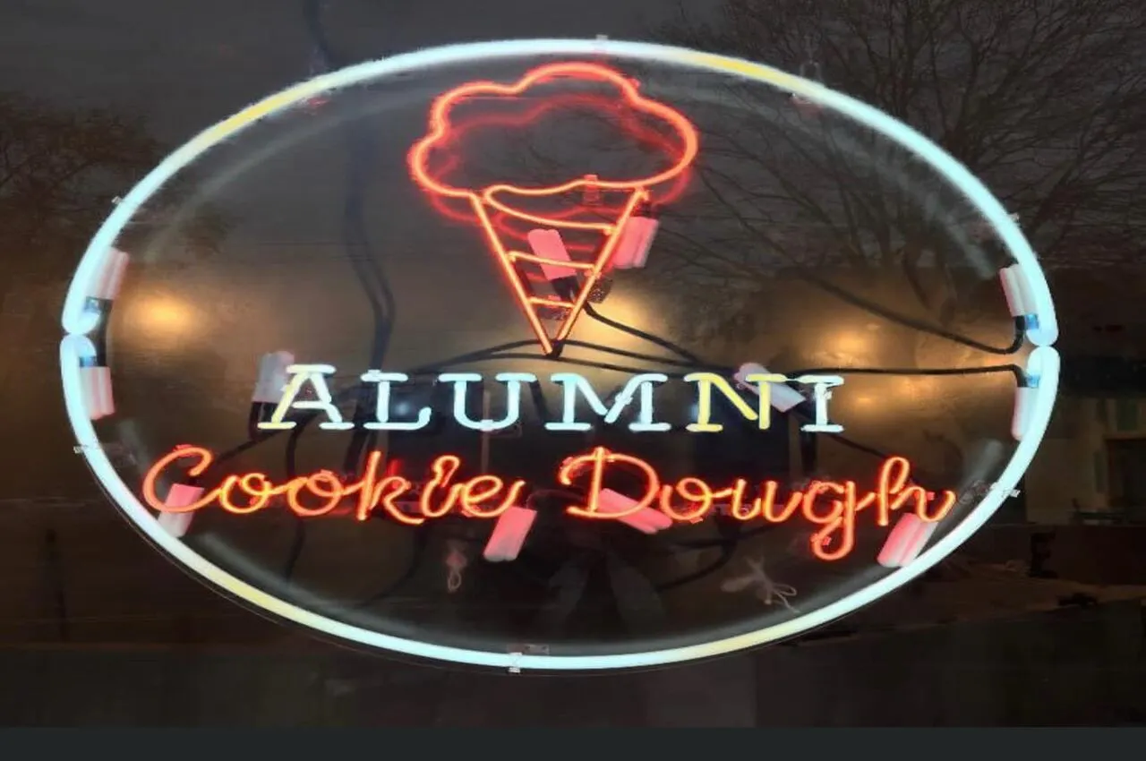 A glass with Alumni Cookie Dough written on it.