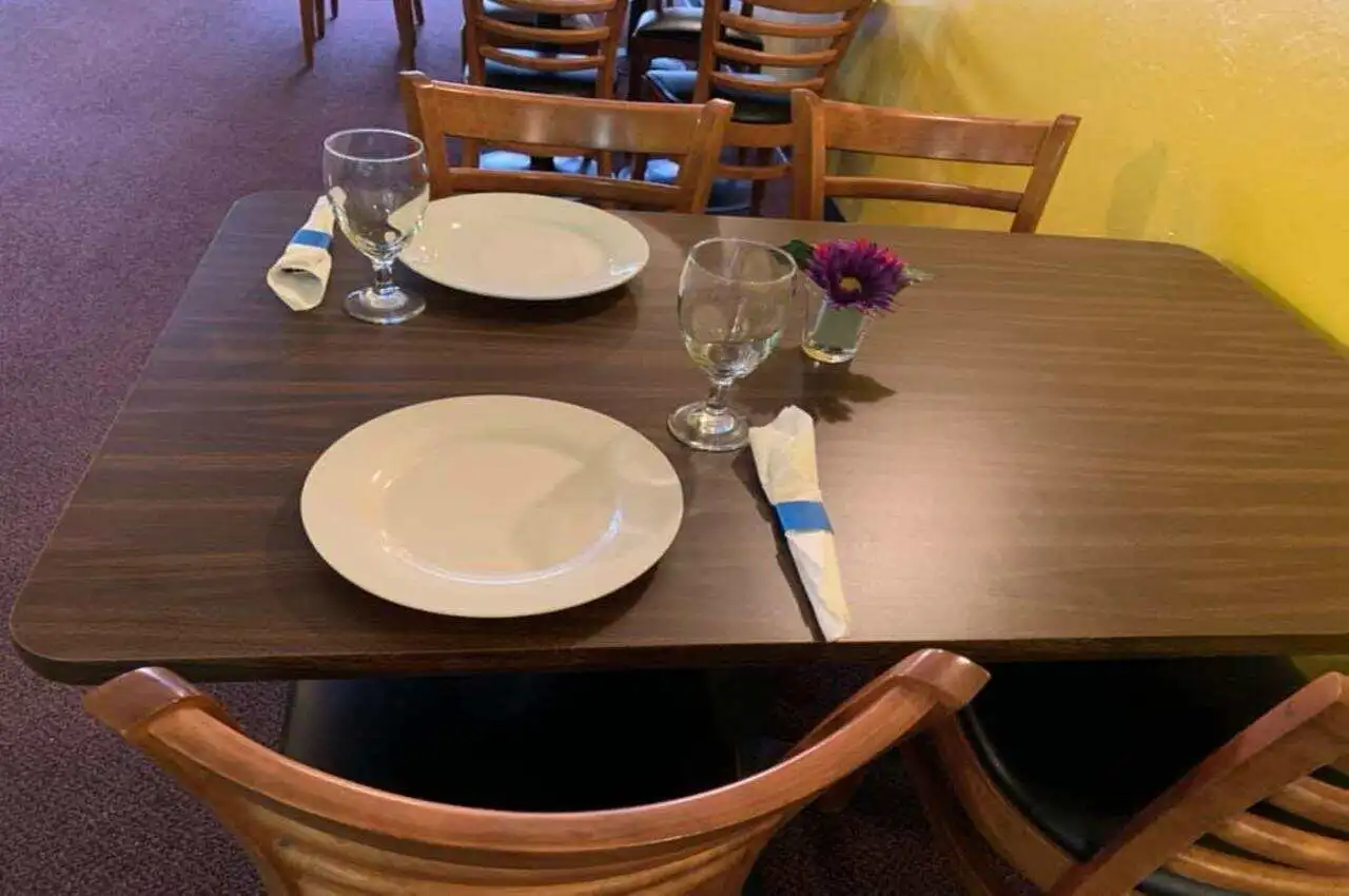 Dining table with a plate and spoon.