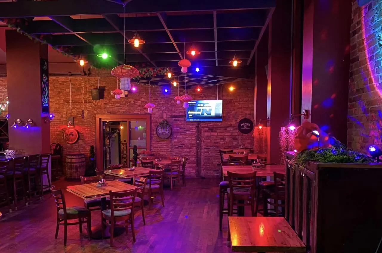 Interior of a rLassale restaurant with red and pink lighting. 