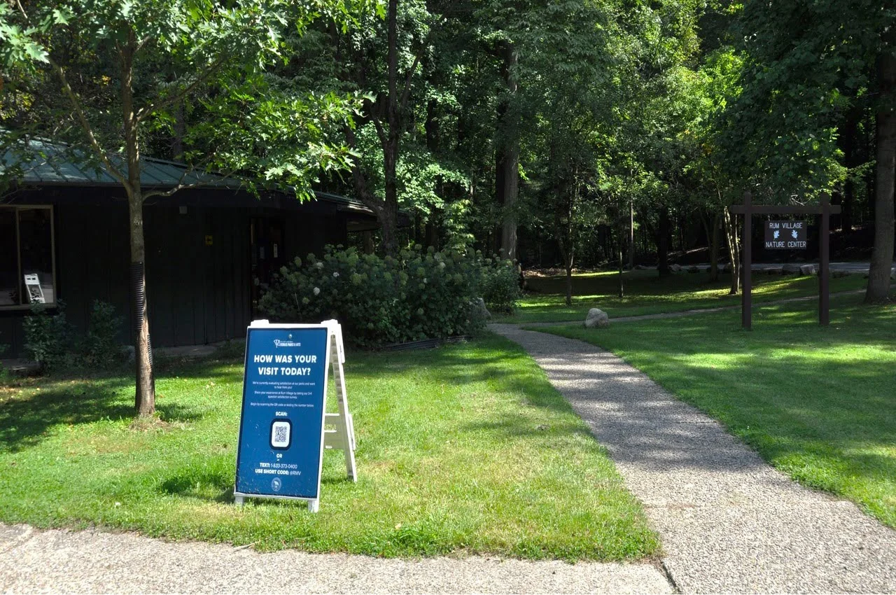 A green area with Rum Village Park board.