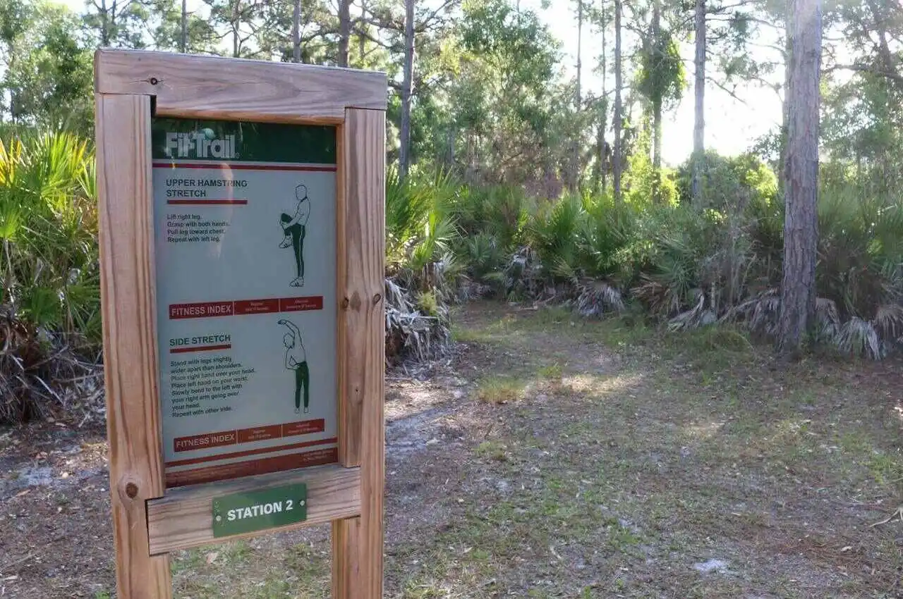 Sign with exercise way in the forest.