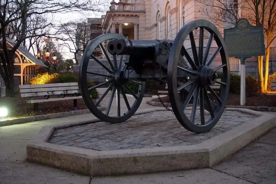 Cannon in front of a building for sightseeing purposes.