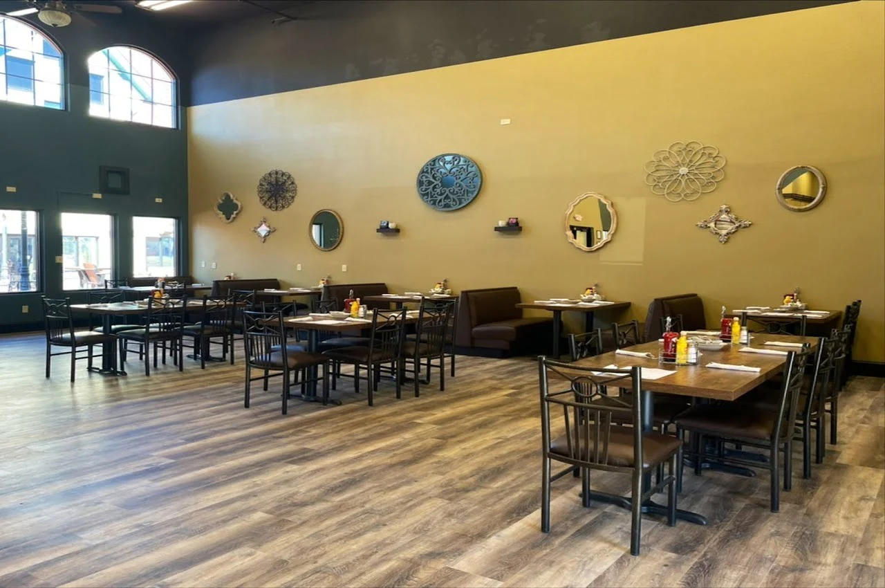 Dining area of a restaurant with art pieces hanging on the walls