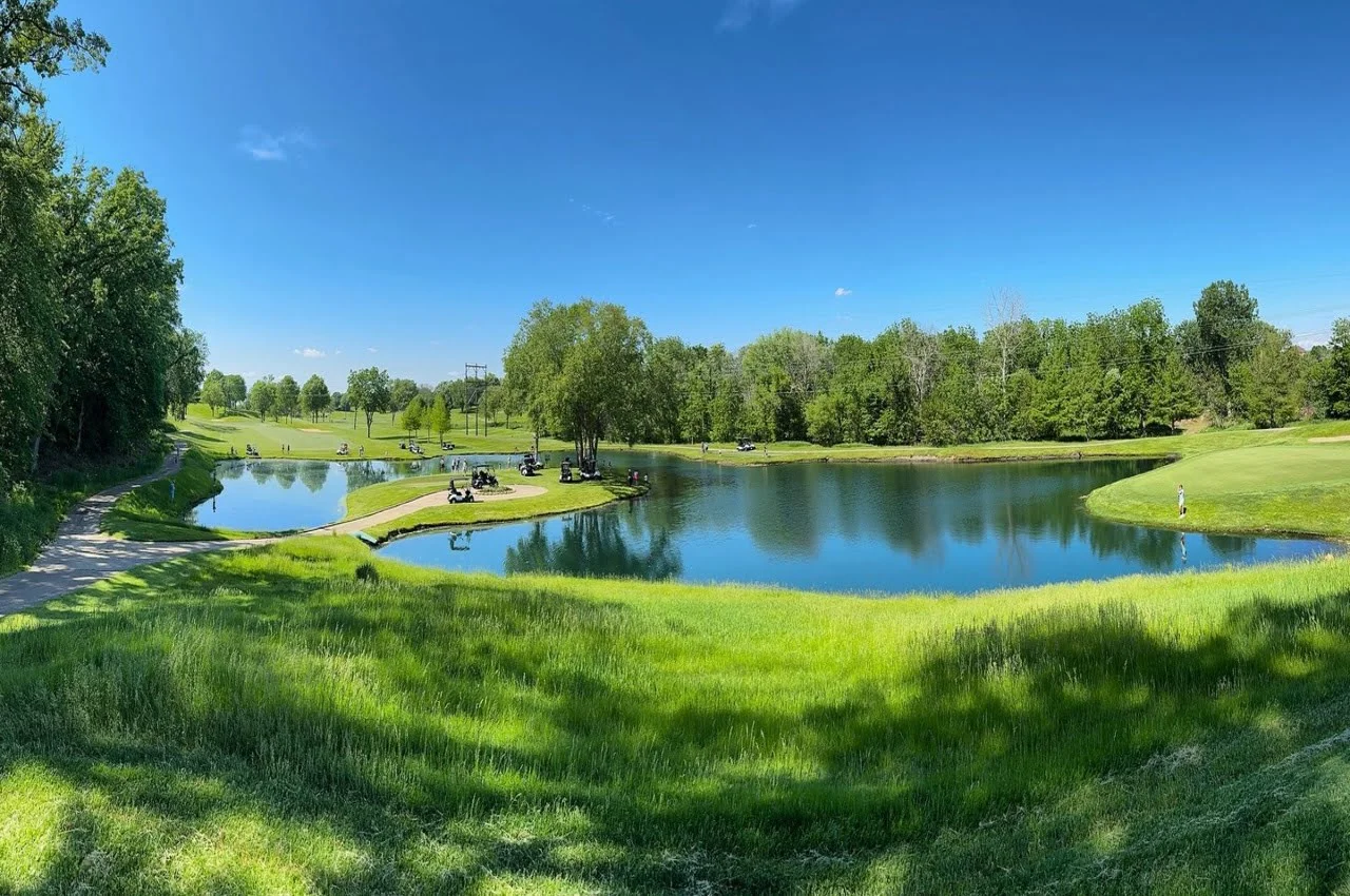 A pond in a golf course.