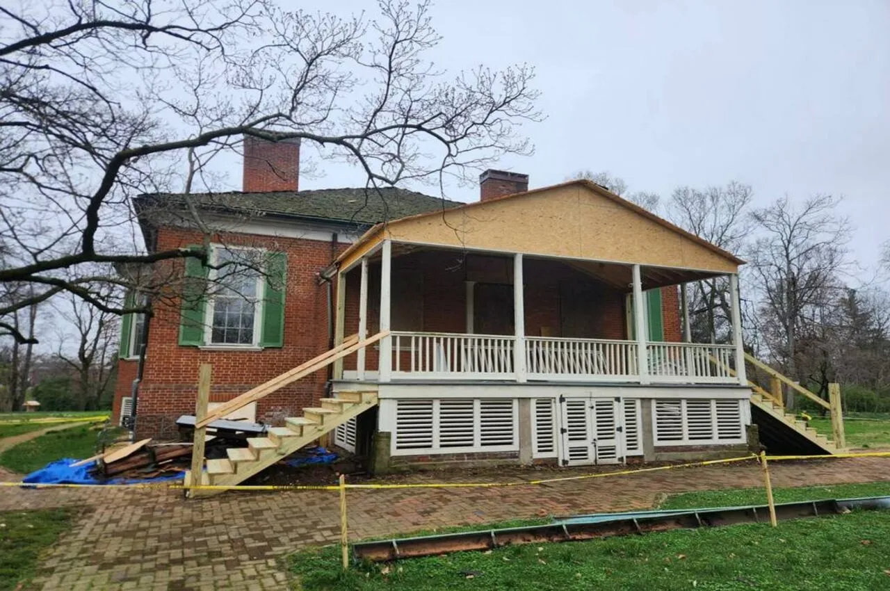 a brick house with a porch and stairs