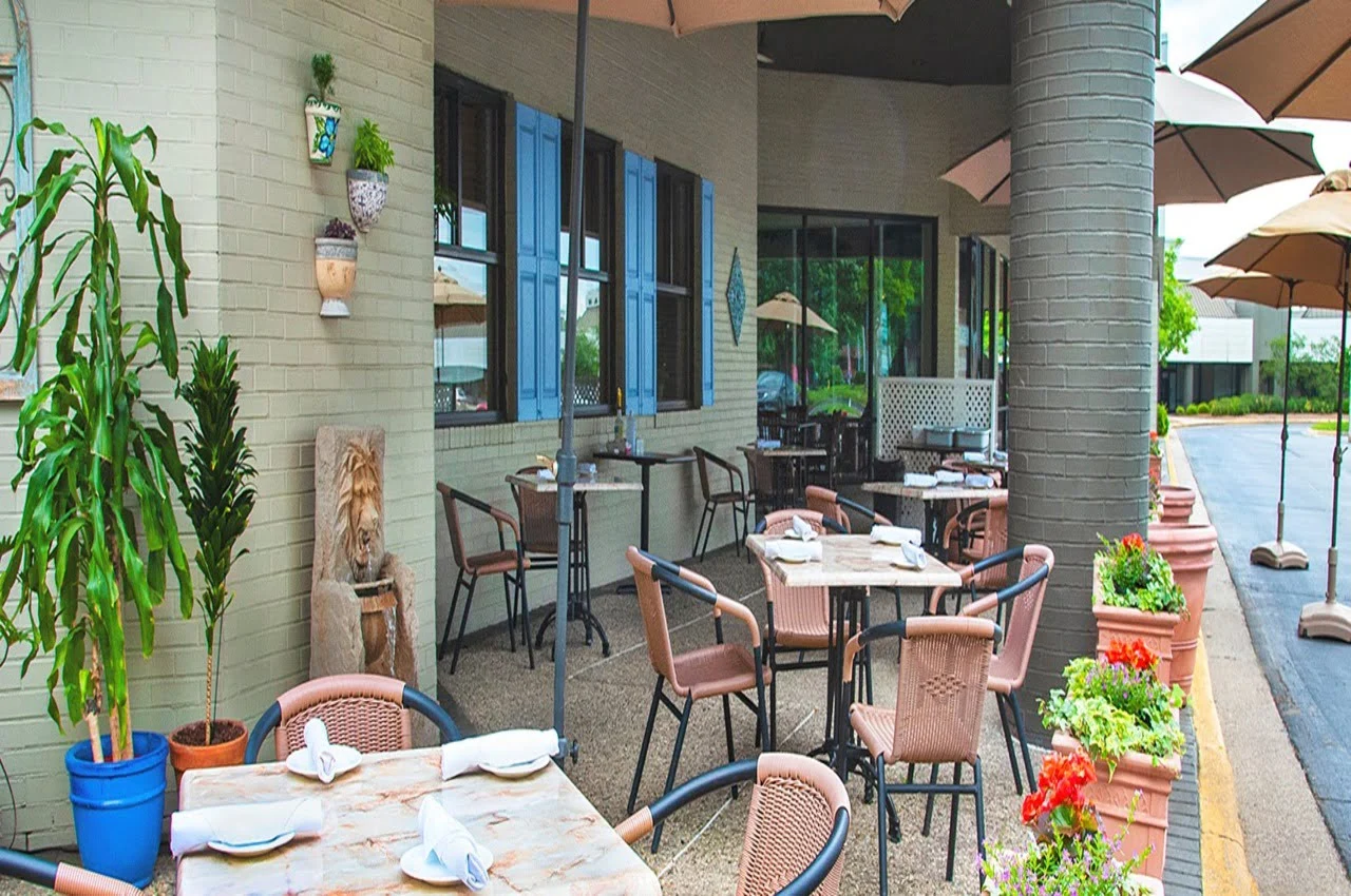 a patio with tables and chairs