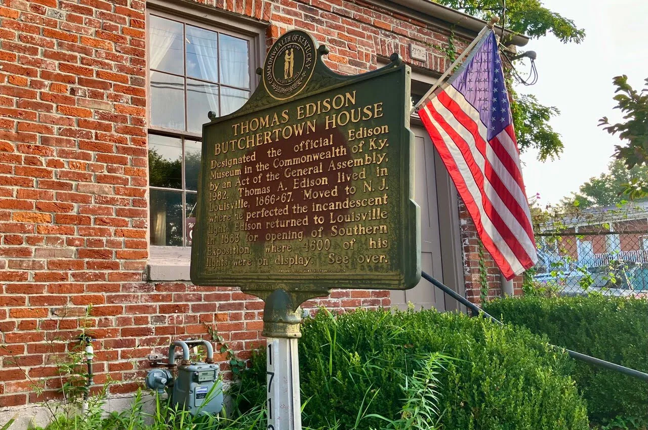 a sign in front of a brick building