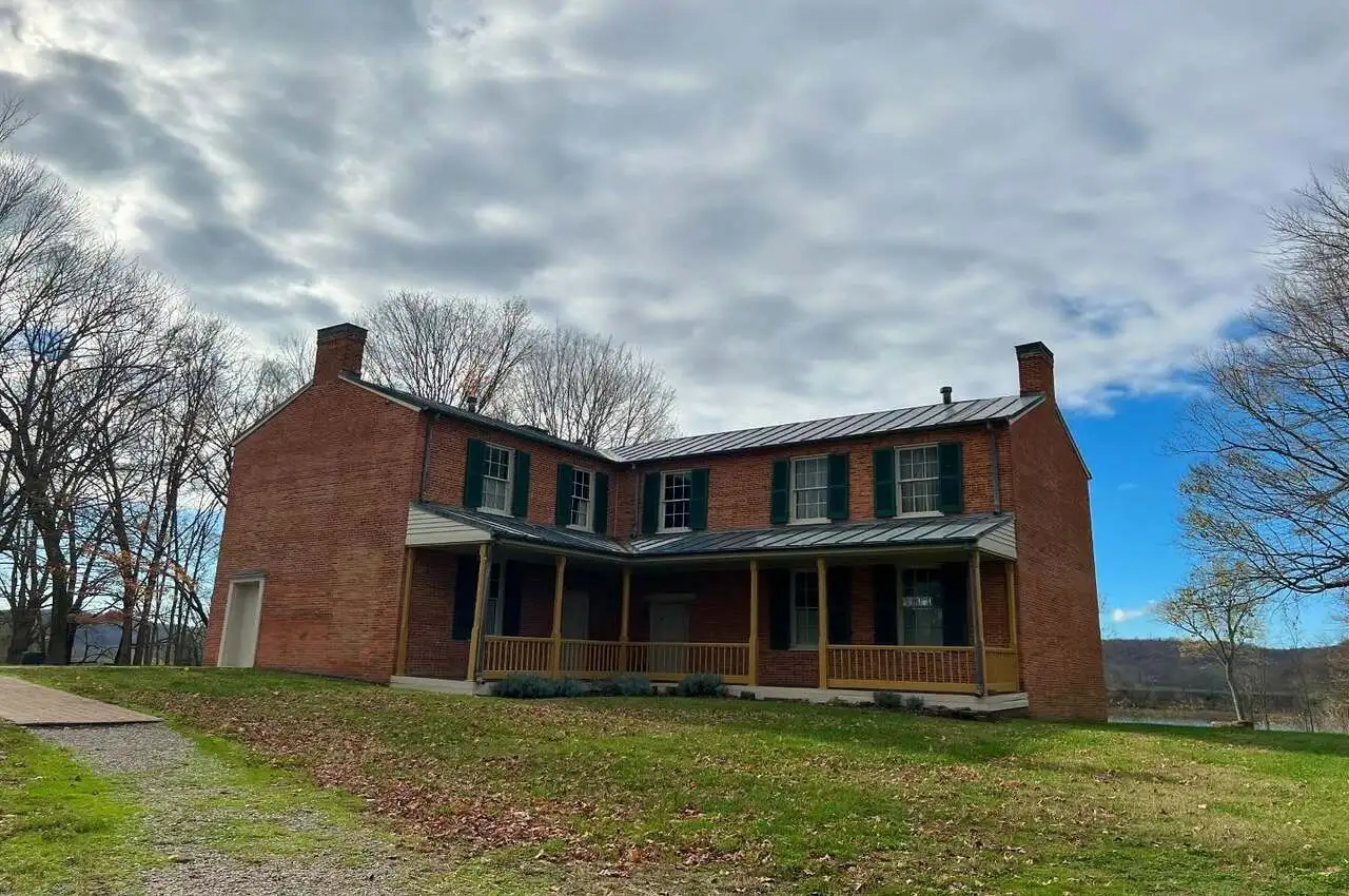 a brick house with a large porch. Among hidden gems in Louisville