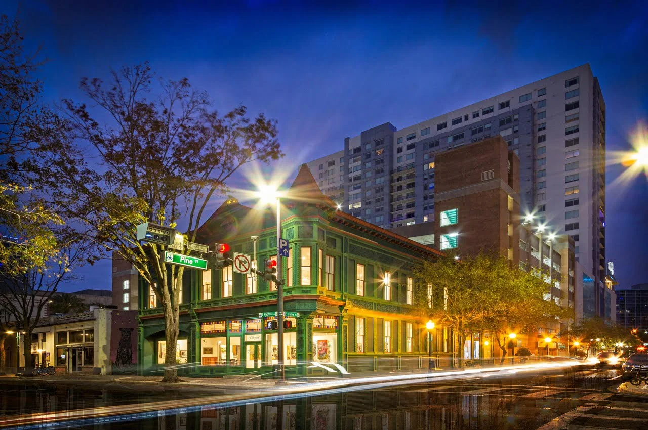 Buildings with traffic lights on the road.