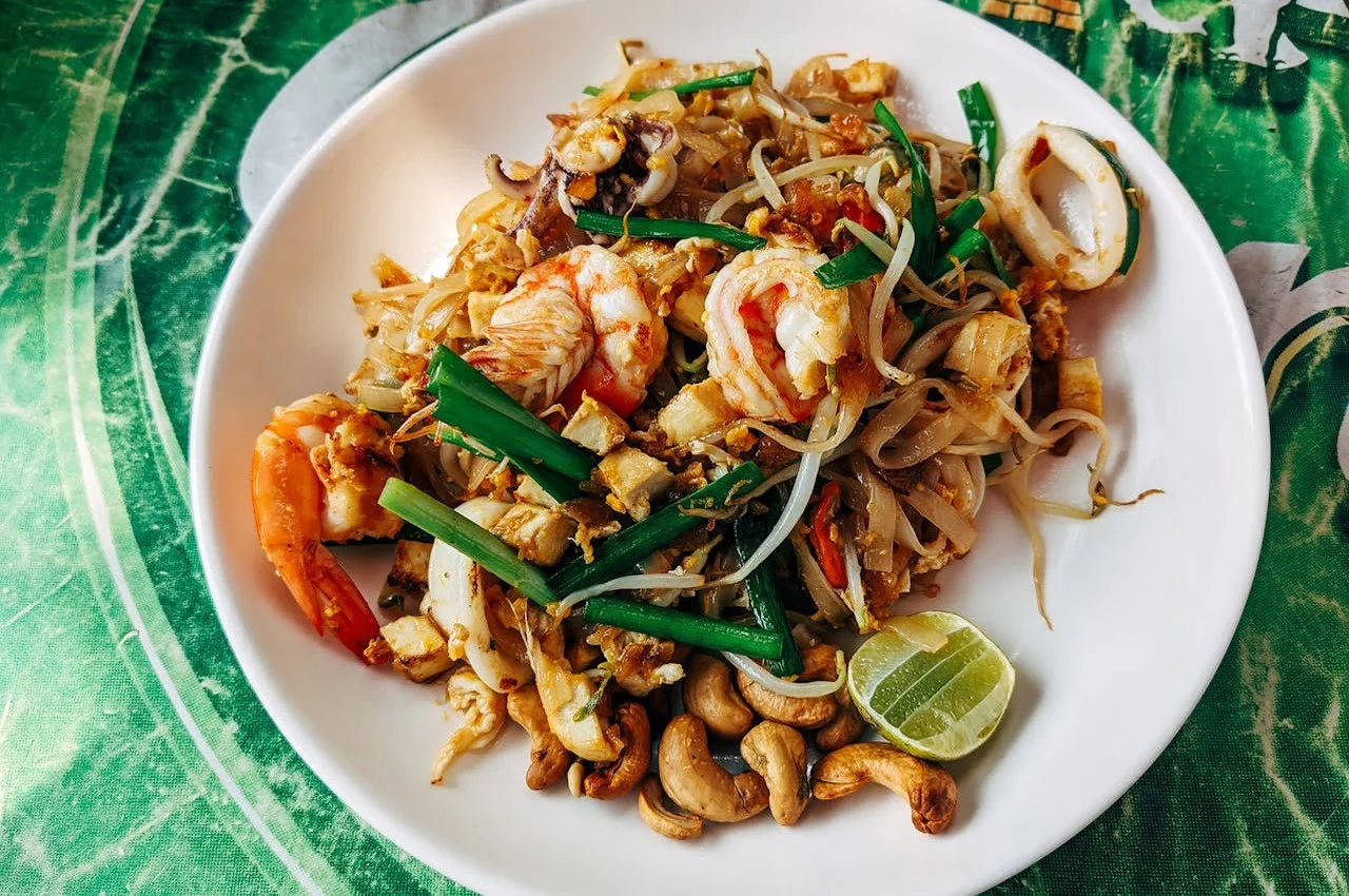 A plate of noodles and shrimp