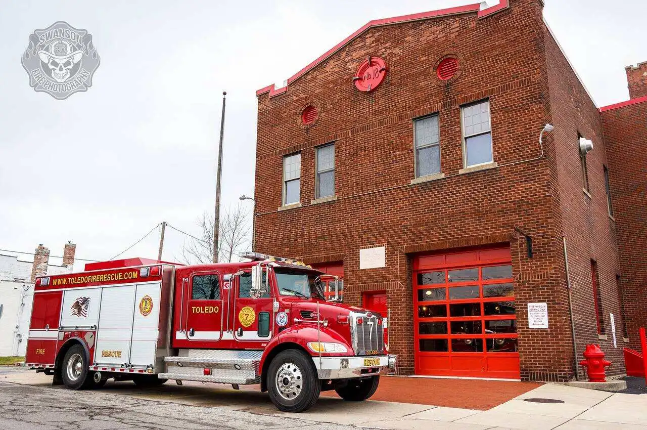 A building and a fire truck standing in front.
