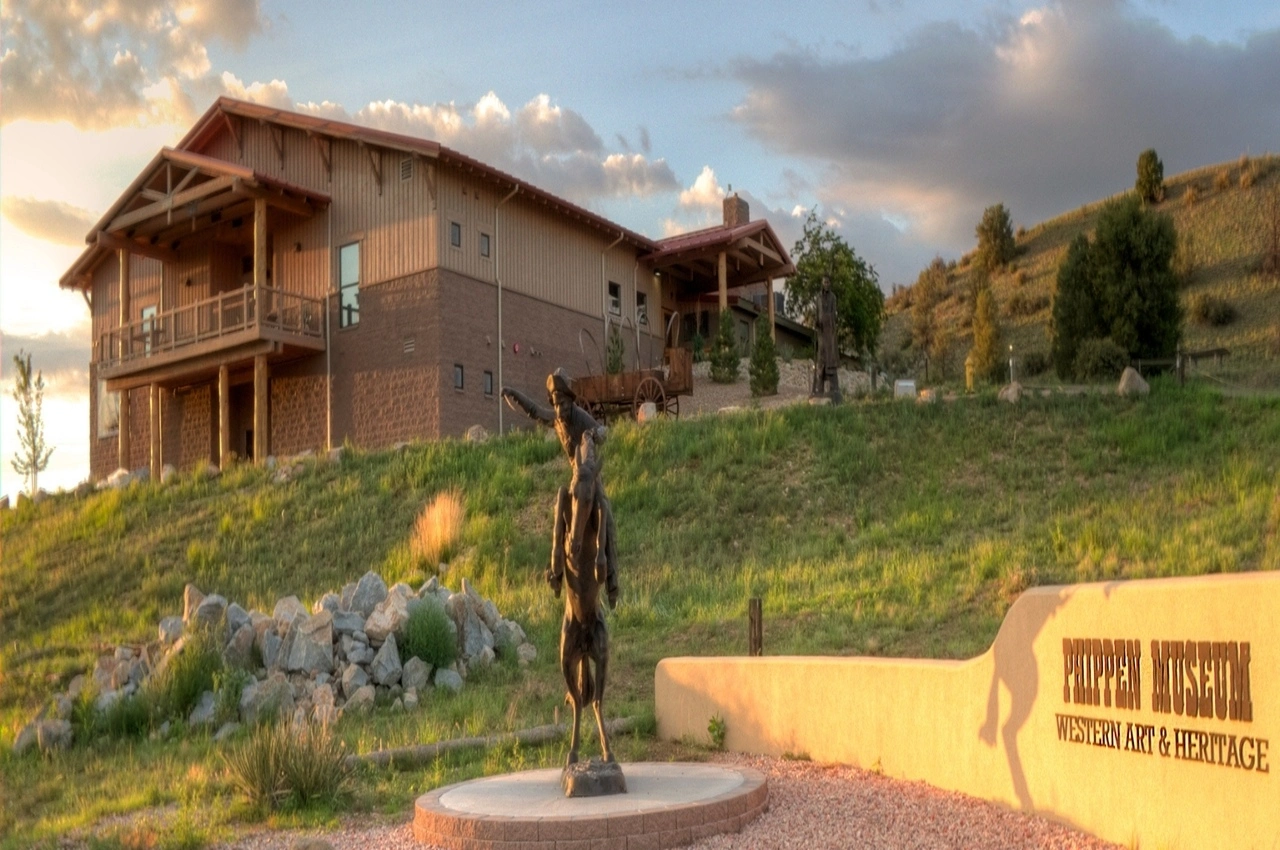 a house and a sculpture in front.