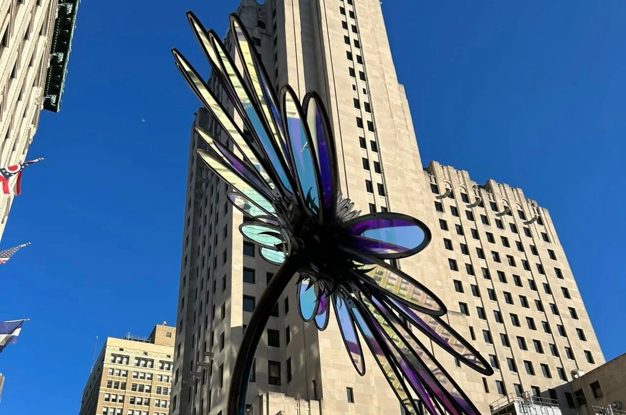 A glass art with a building on the back.
