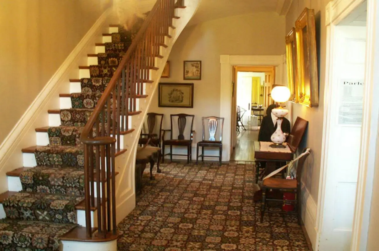 Stairs of a home with chairs in the room