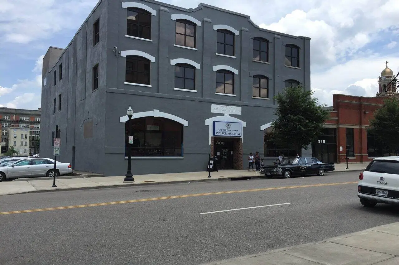 A building with cars parked in front.