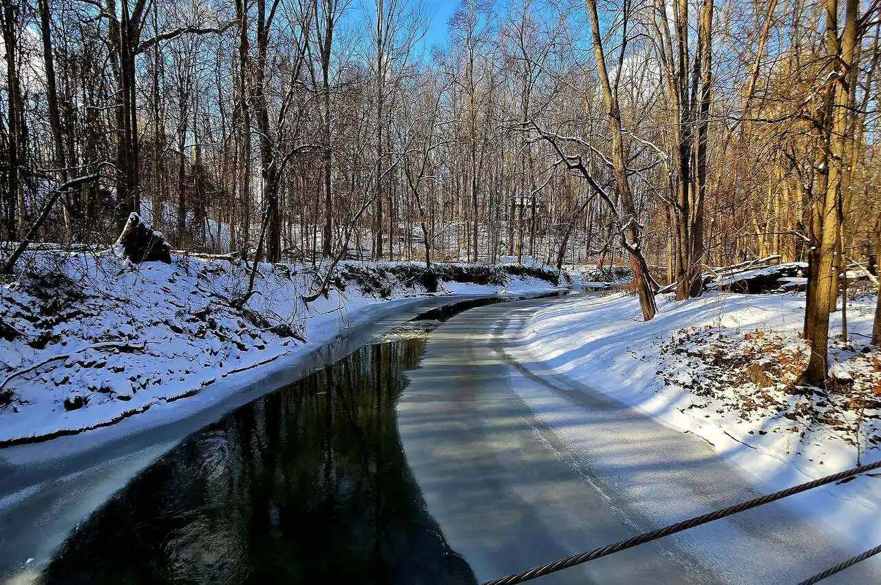 A creek with snowy surroundings.