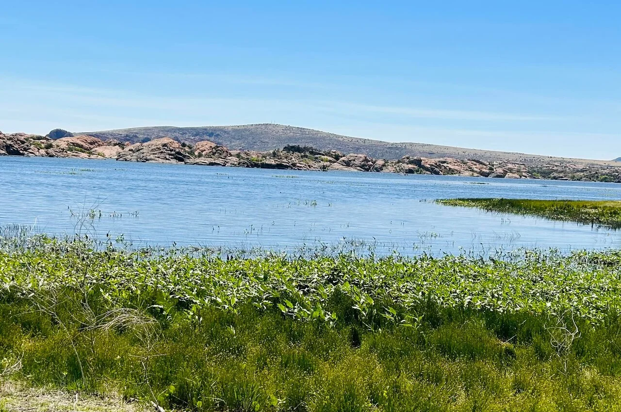 a lake with rocks on the other side.