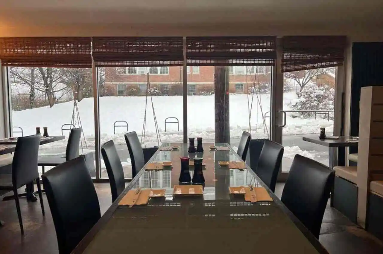 Seating area of a restaurant with views of snow outside