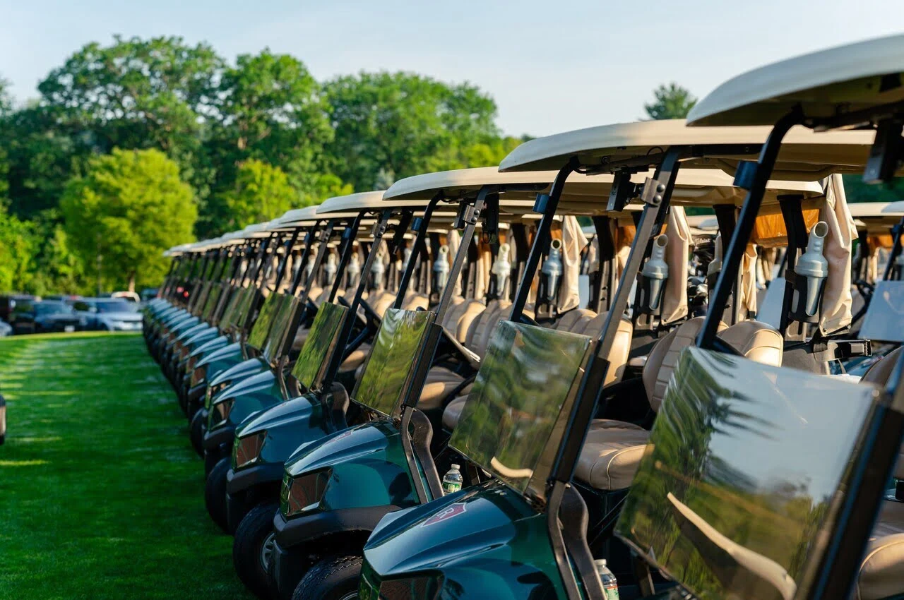 Golf carts standing in line.
