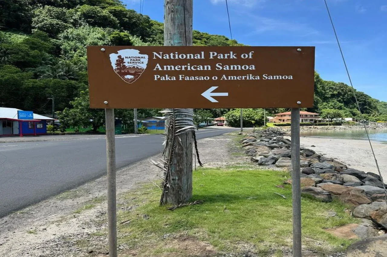 A signboard directing towards the National Park of American Samoa.