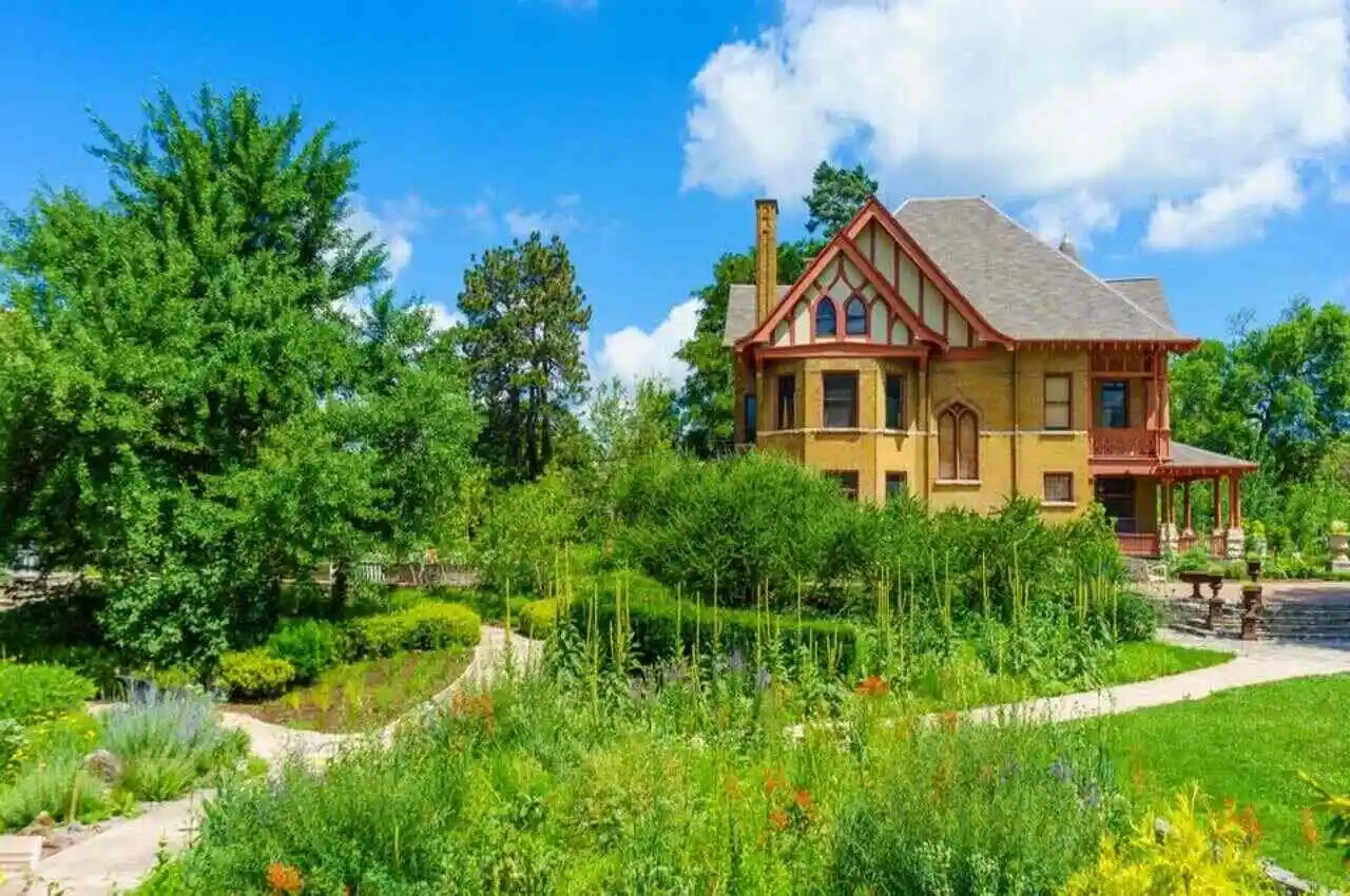 A garden with house on the side.