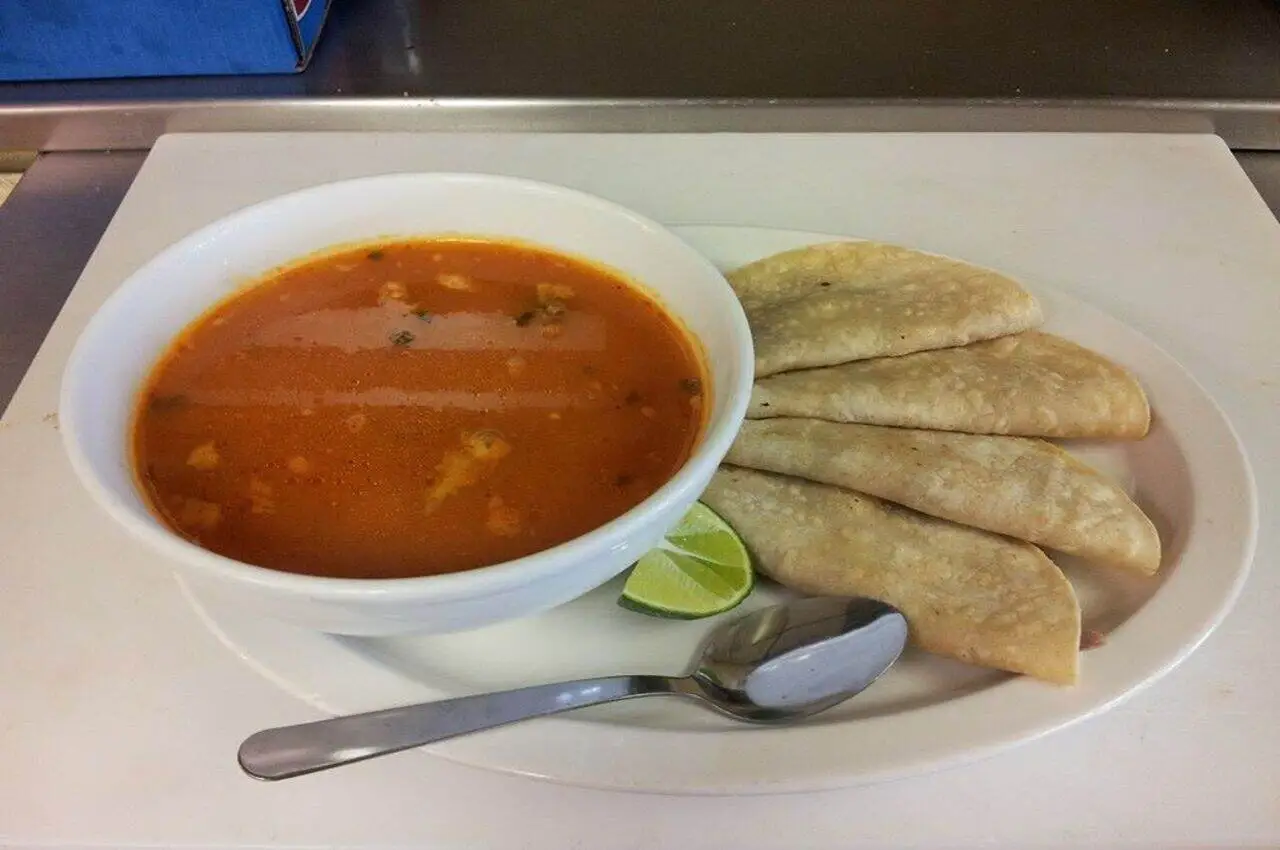 Tacos and gravy on a plate.